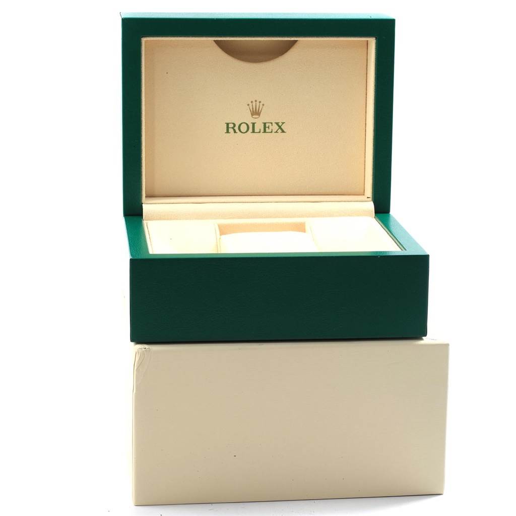 The image shows an open green and beige Rolex box, likely for a GMT-Master model watch.