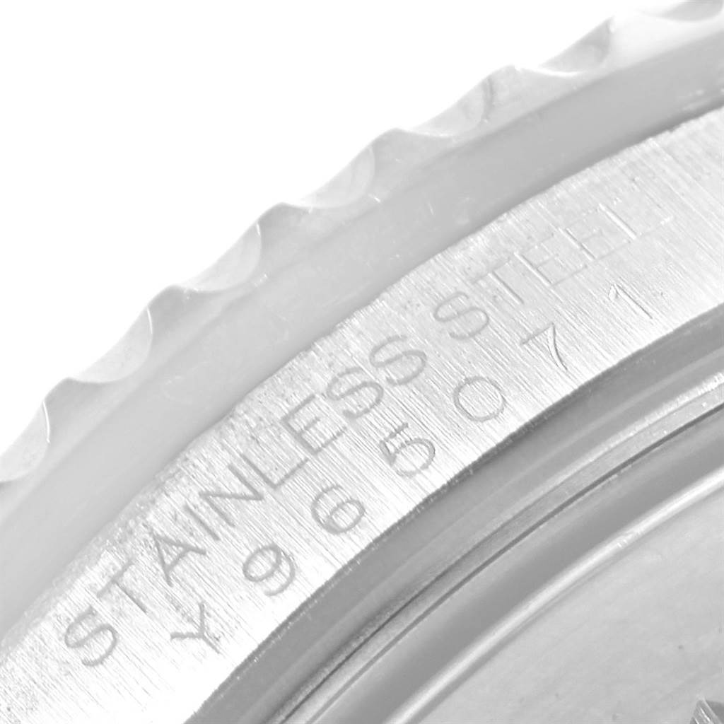 This close-up image of a Rolex GMT-Master 16710 Men's Stainless Steel Black Dial 16710 Men's Stainless Steel Black Dial watch shows the bezel and part of the engraved stainless steel case.