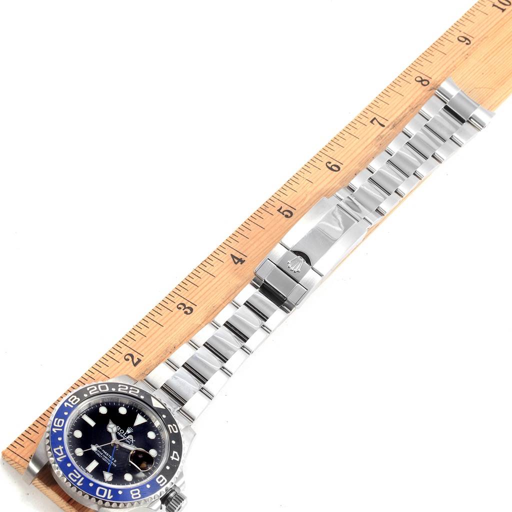 The image shows the dial, bezel, and bracelet of a Rolex GMT-Master 116710 Men
s Stainless Steel Black Dial 116710 Men
s Stainless Steel Black Dial watch, positioned next to a ruler.