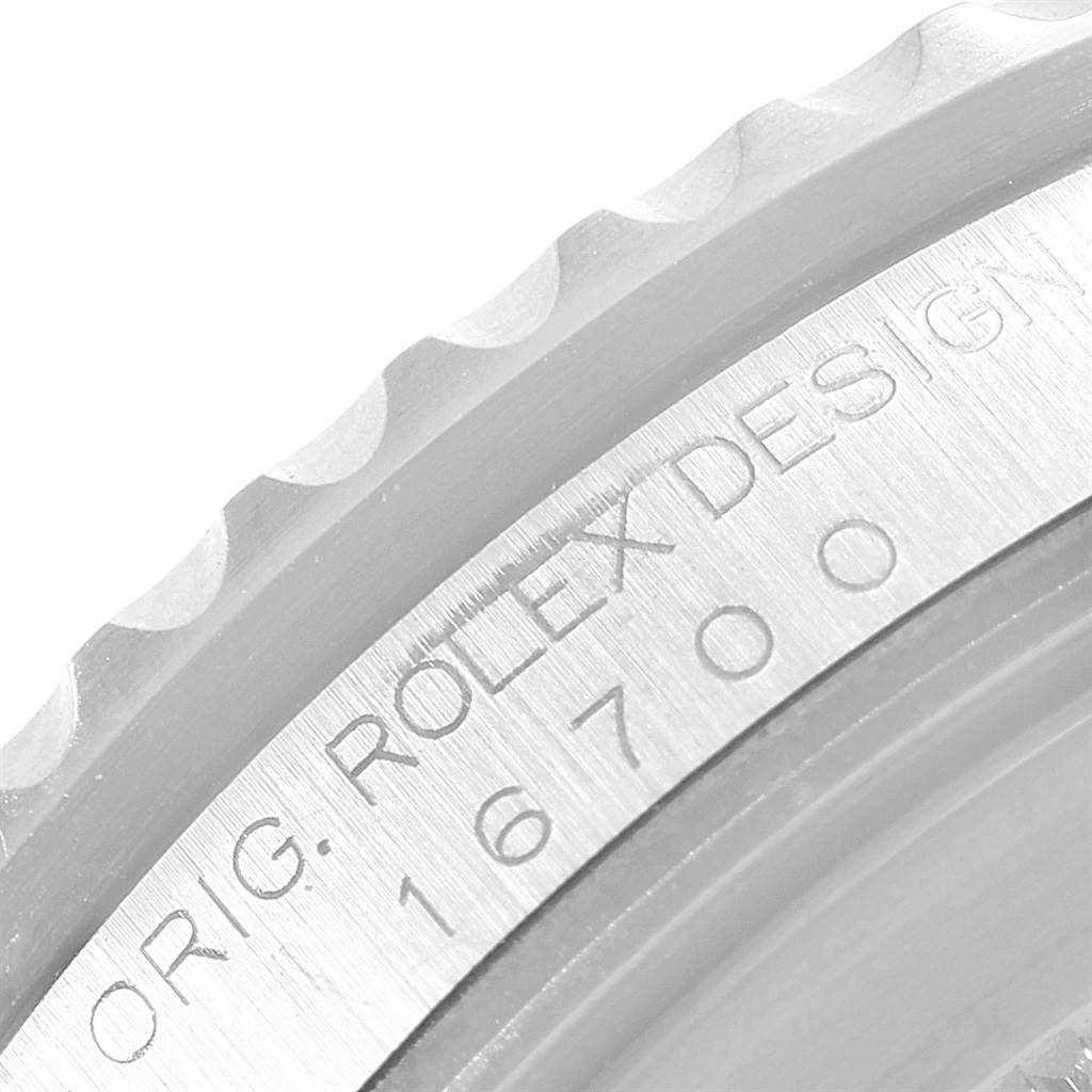 This close-up image shows the engraved bezel and case side of a Rolex GMT-Master 16700 Men's Stainless Steel Black Dial 16700 Men's Stainless Steel Black Dial model.