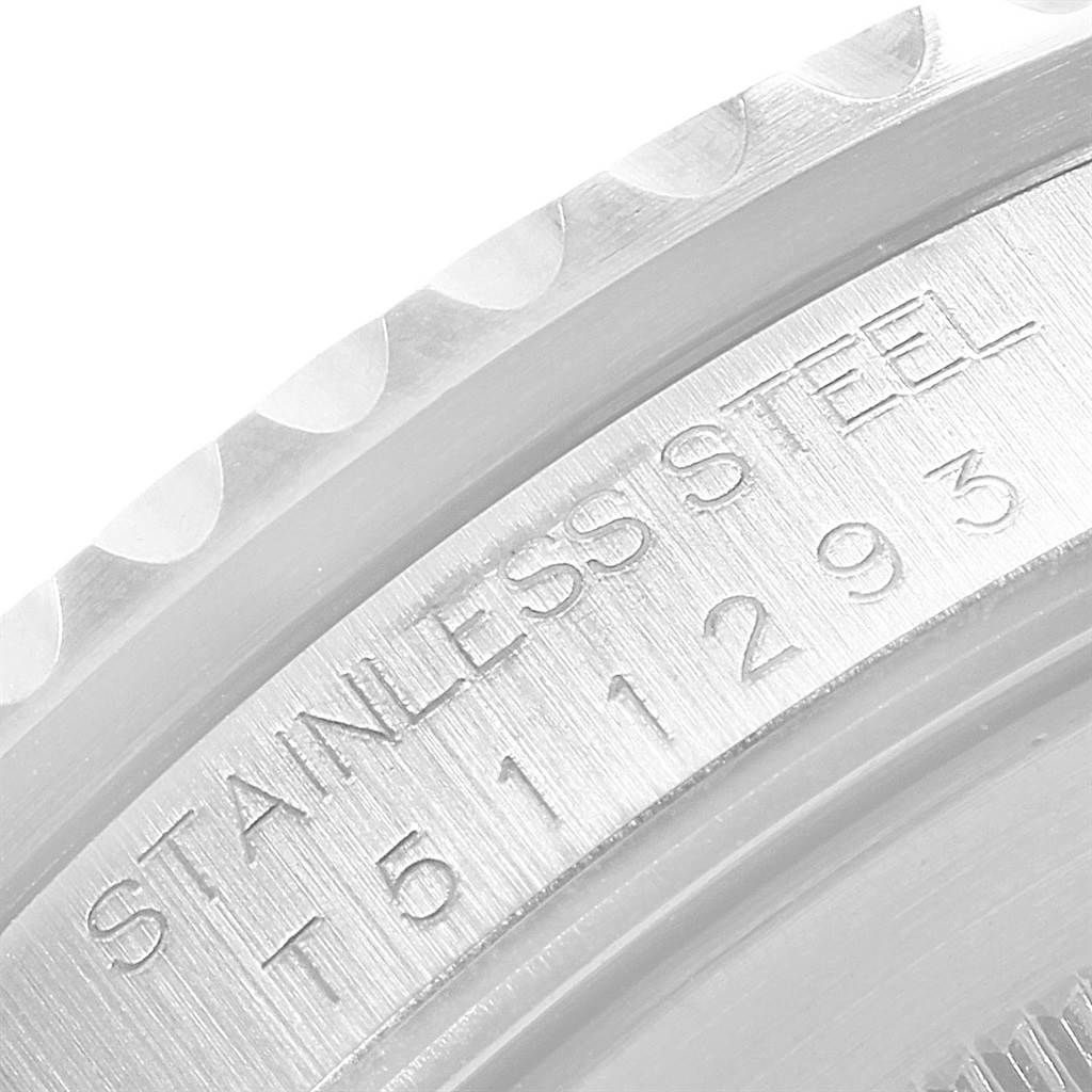 This image shows a close-up of the stainless steel bezel and serial number inscription on a Rolex GMT-Master 16700 Men's Stainless Steel Black Dial 16700 Men's Stainless Steel Black Dial watch.