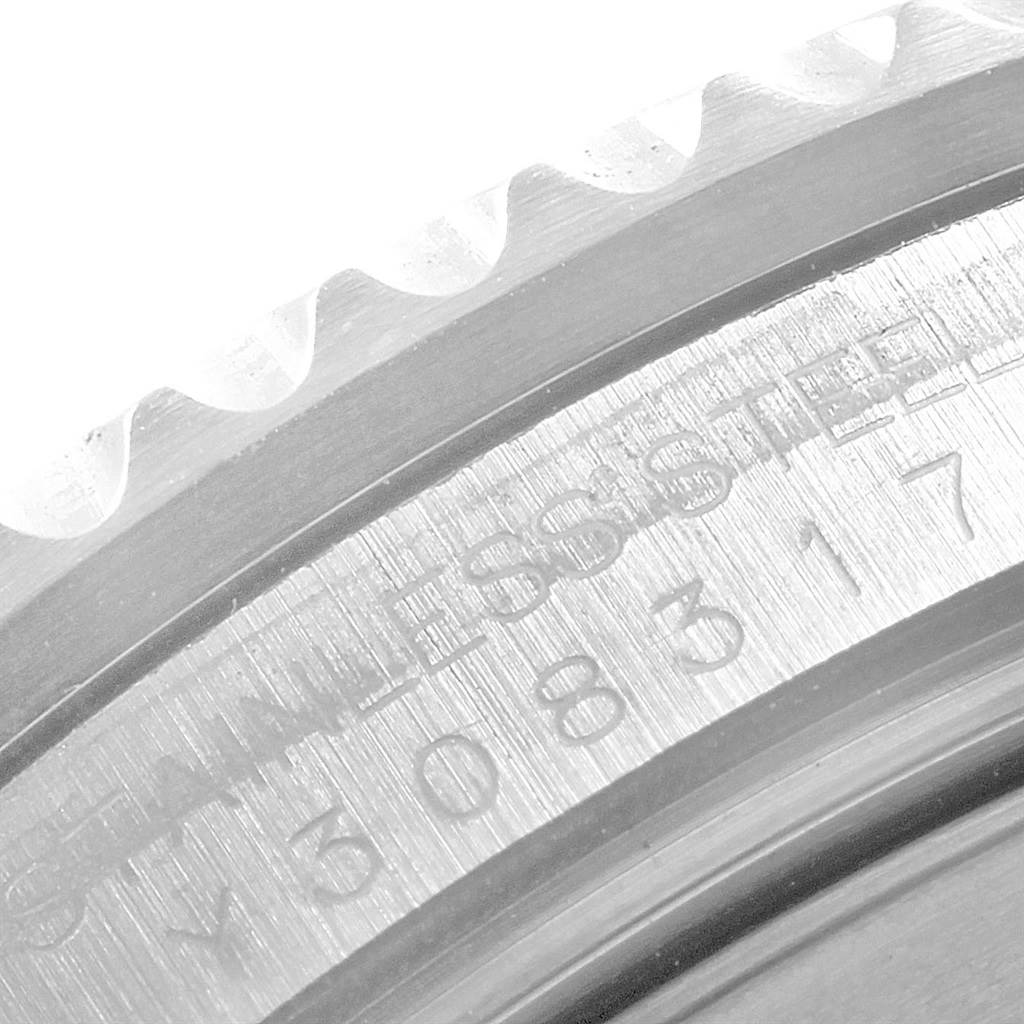 This close-up image shows the engraved bezel and part of the stainless steel case of the Rolex GMT-Master 16710 Men's Stainless Steel Black Dial 16710 Men's Stainless Steel Black Dial.