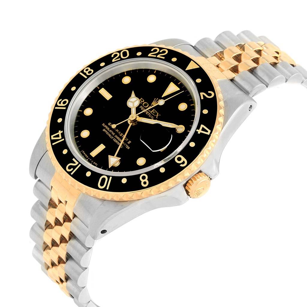 This is an angled view of the Rolex GMT-Master 16713 Men's Stainless Steel Black Dial 16713 Men's Stainless Steel Black Dial II, highlighting the bezel, dial, crown, and two-tone bracelet.