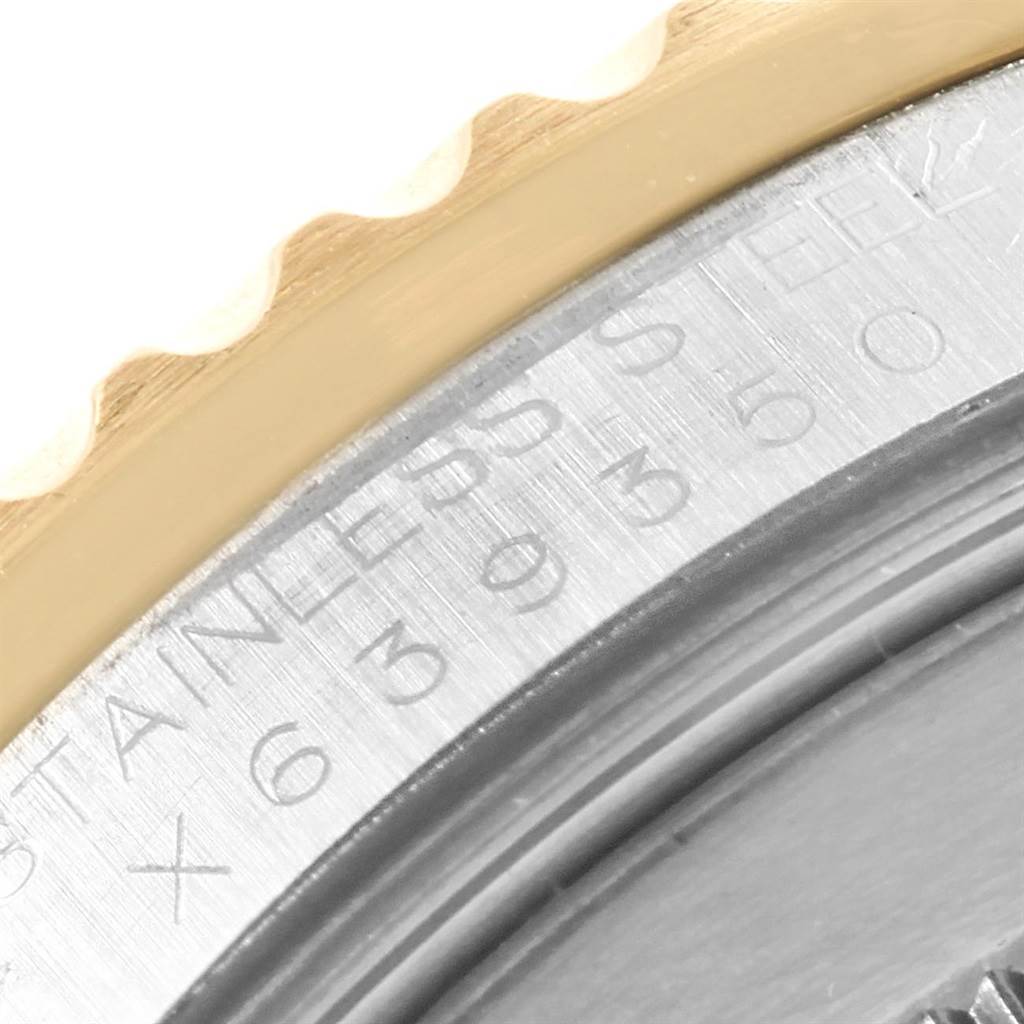 The image shows a close-up view of the side of a Rolex GMT-Master 16713 Men's Stainless Steel Black Dial 16713 Men's Stainless Steel Black Dial, focusing on the bezel and part of the engraved text on the case.