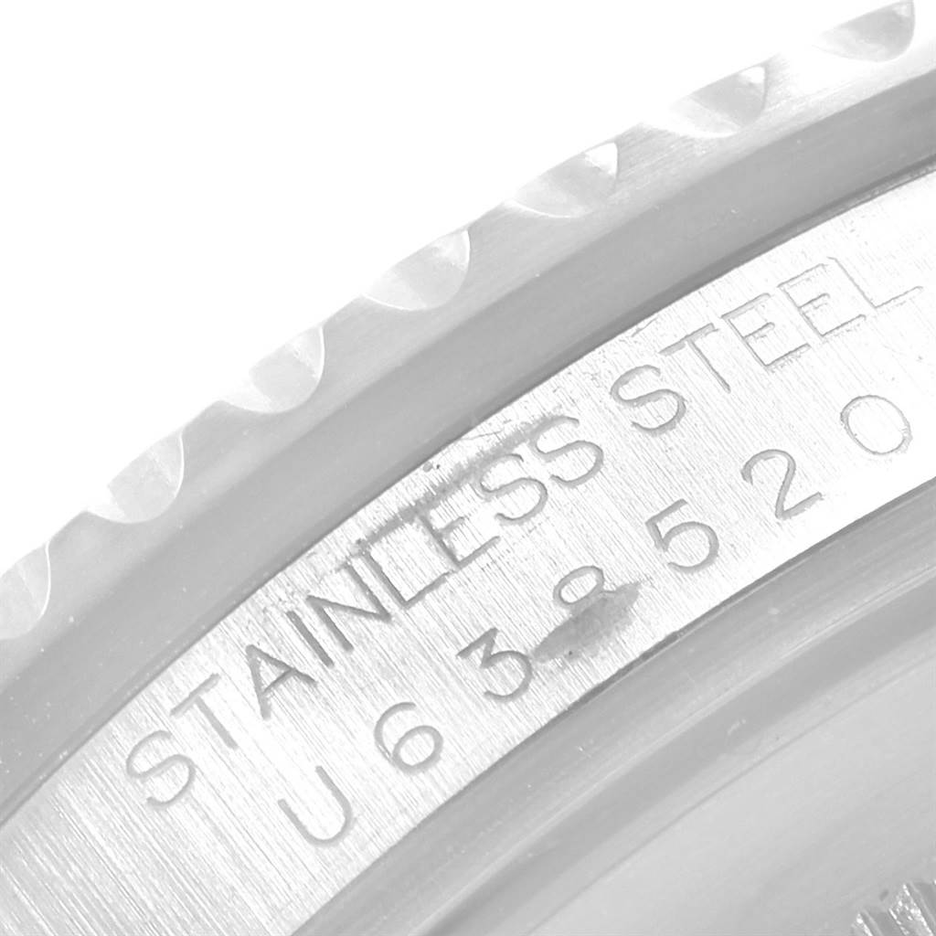 The image shows a close-up of the side engraving on the bezel of a Rolex GMT-Master 16700 Men's Stainless Steel Black Dial 16700 Men's Stainless Steel Black Dial watch, highlighting the "STAINLESS STEEL" text and serial number.