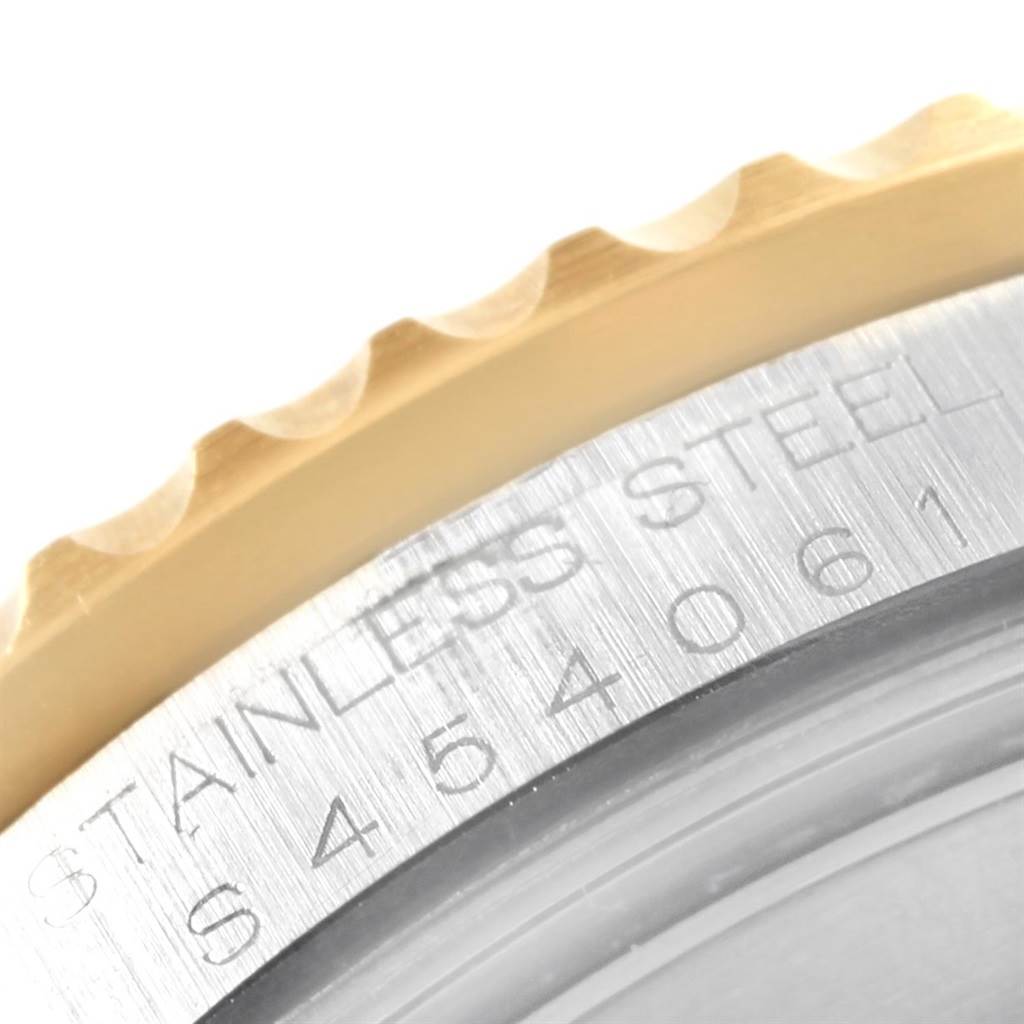 The image shows a close-up of the engraved bezel edge and part of the stainless steel case of a Rolex GMT-Master 16713 Men's Stainless Steel Brown Dial 16713 Men's Stainless Steel Brown Dial watch.