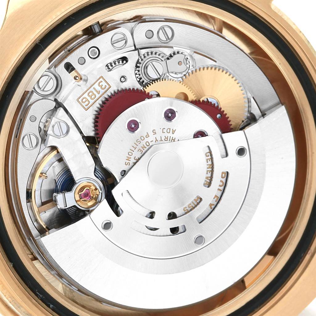 The image shows a close-up of the movement mechanism of a Rolex GMT-Master 116718 Men
s Yellow Gold Black Dial 116718 Men
s Yellow Gold Black Dial watch.