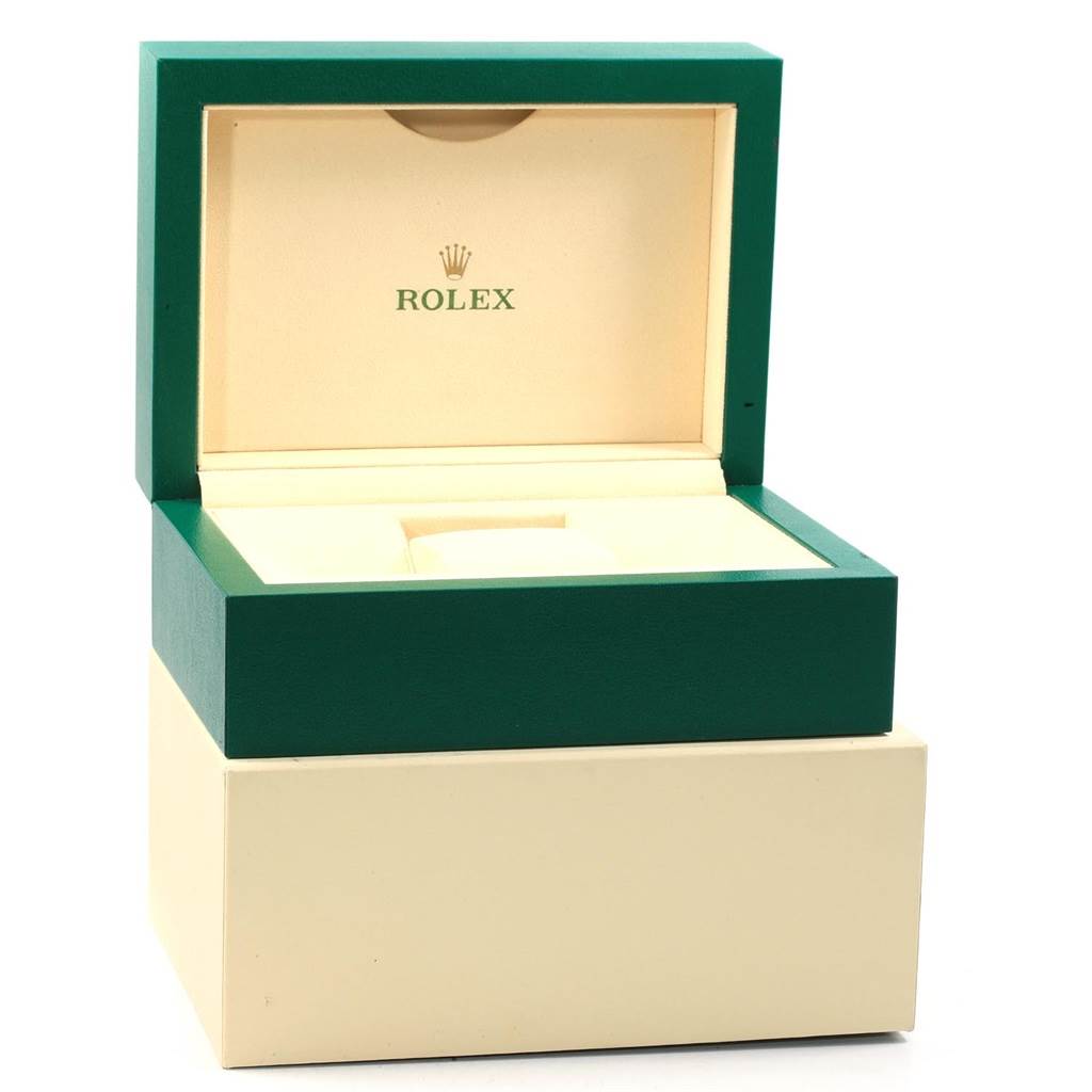 The image shows an open green and beige Rolex box for the GMT-Master model.