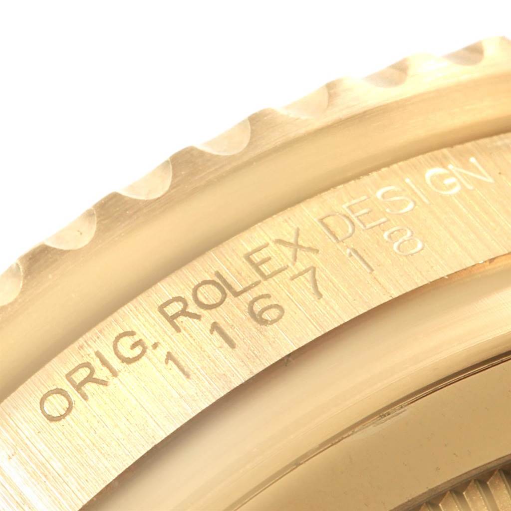 This close-up angle shows the engraved bezel and part of the case of a Rolex GMT-Master 116718 Men
s Yellow Gold Black Dial 116718 Men
s Yellow Gold Black Dial watch.