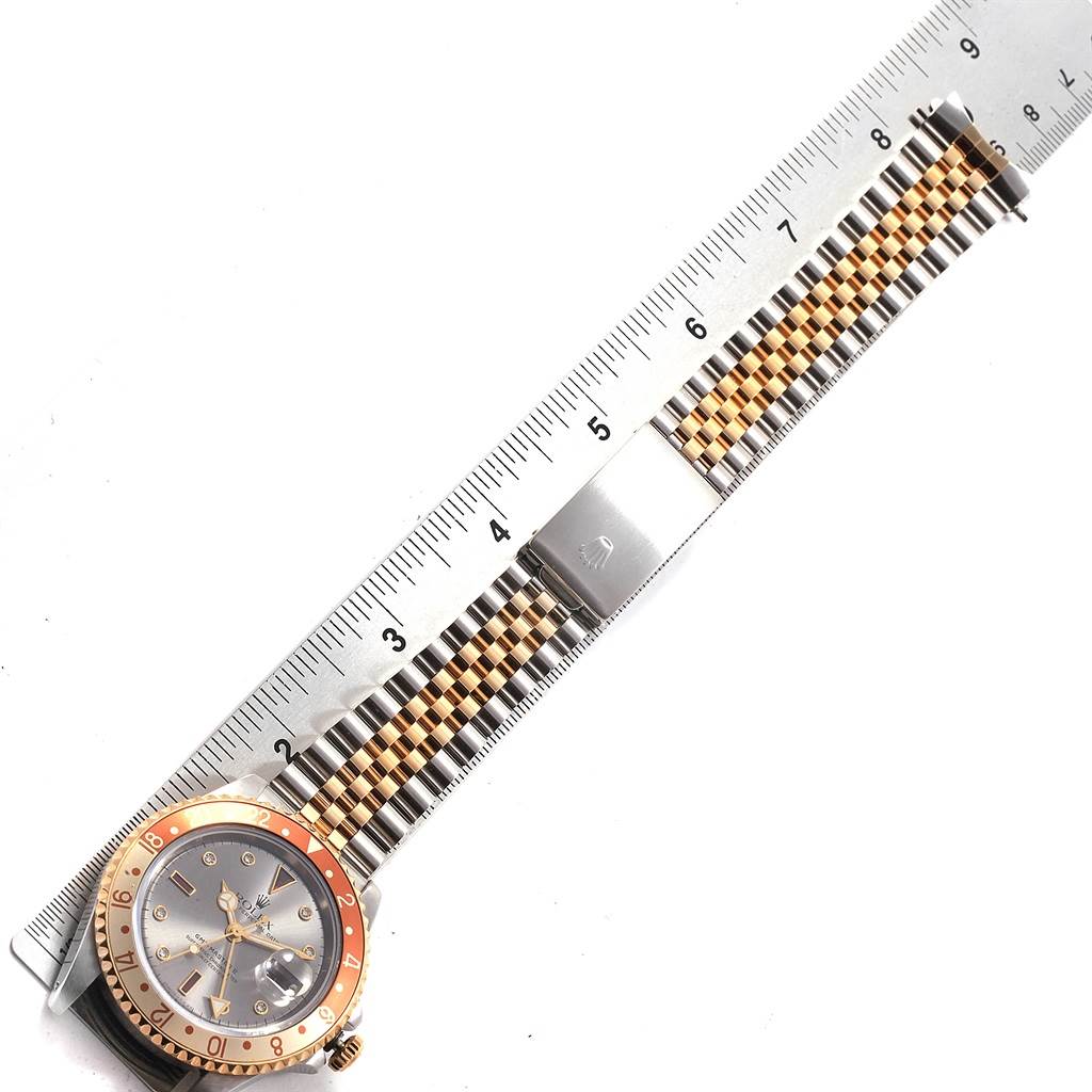 The image shows the Rolex GMT-Master 16713 Men's Stainless Steel Grey Dial 16713 Men's Stainless Steel Grey Dial watch laid flat with its bracelet extended along a ruler for measurement.