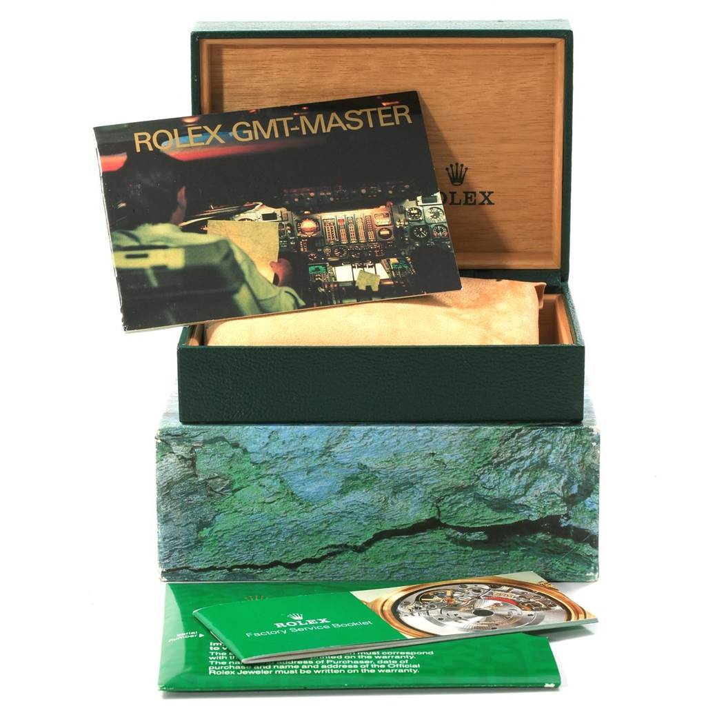 The image shows the packaging, manuals, and a booklet for the Rolex GMT-Master 16713 Men's Stainless Steel Grey Dial 16713 Men's Stainless Steel Grey Dial watch, with no watch visible.