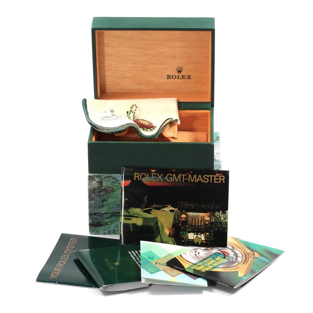 The image shows a Rolex GMT-Master 16710 Men's Stainless Steel Black Dial 16710 Men's Stainless Steel Black Dial watch box, a pouch, various manuals, and booklets at an elevated angle.