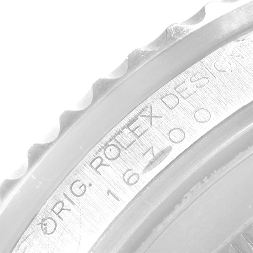 The image shows a close-up of the bezel and case edge of a Rolex GMT-Master 16700 Men's Stainless Steel Black Dial 16700 Men's Stainless Steel Black Dial watch, highlighting its engraved markings.