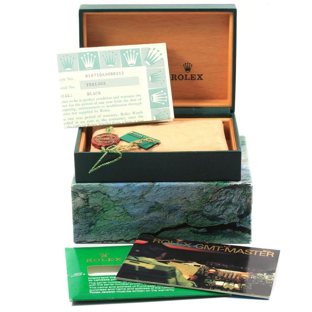 The image shows a Rolex GMT-Master 16710 Men's Stainless Steel Black Dial 16710 Men's Stainless Steel Black Dial watch box, warranty card, tags, and manuals from a frontal angle.