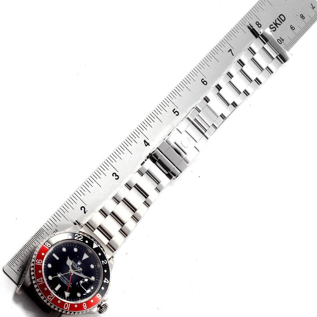 The image shows a top-down view of a Rolex GMT-Master 16710 Men's Stainless Steel Black Dial 16710 Men's Stainless Steel Black Dial watch, with a ruler measuring its bracelet length.