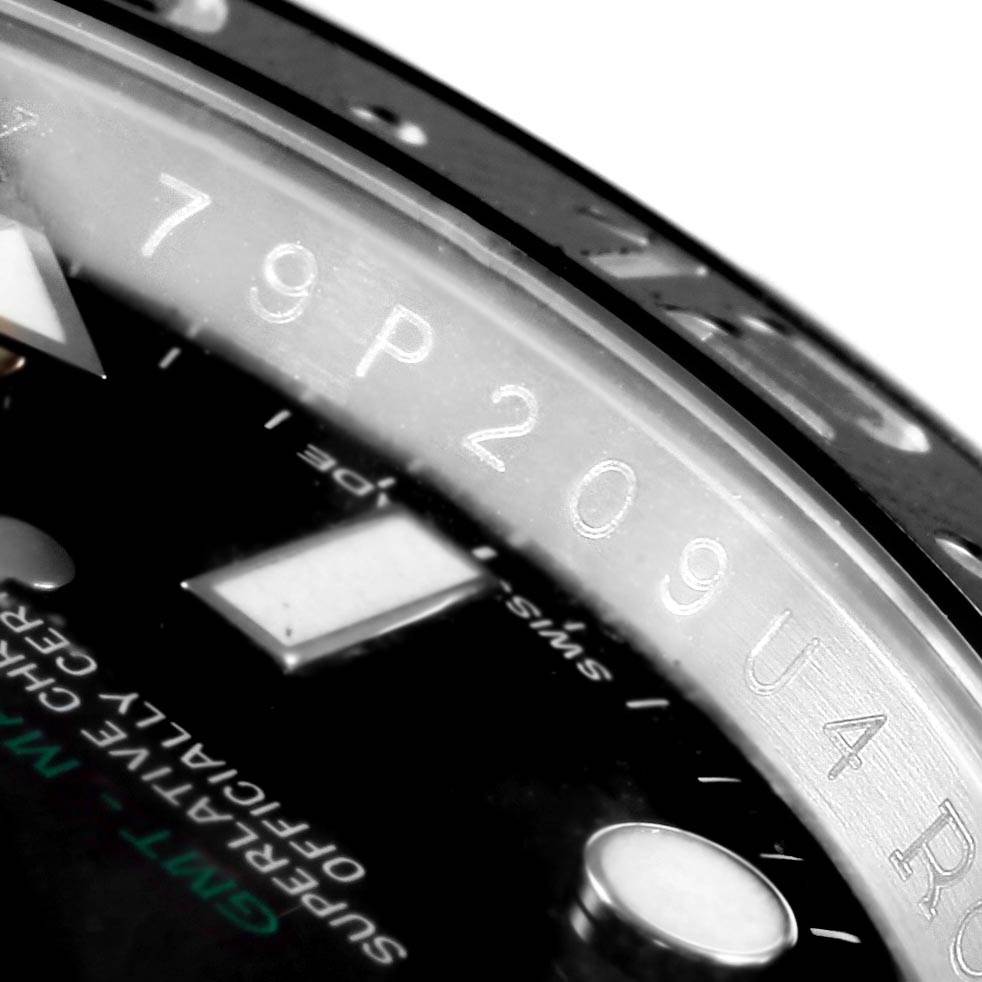 This close-up image shows the GMT-Master model by Rolex, focusing on the bezel and part of the dial with the model name.