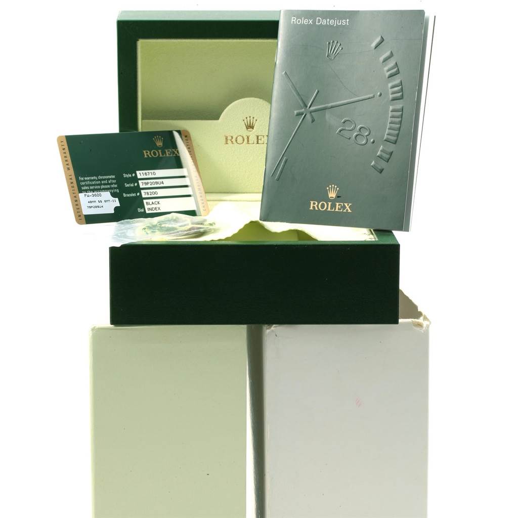 This image shows the packaging, warranty card, and manuals for a Rolex GMT-Master 116710 Men
s Stainless Steel Black Dial 116710 Men
s Stainless Steel Black Dial watch from an angled view.