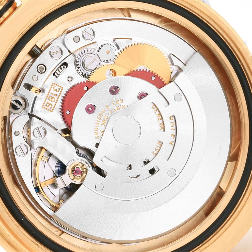 This image shows the intricate mechanical movement of a Rolex GMT-Master 116718 Men's Yellow Gold Green Dial 116718 Men's Yellow Gold Green Dial watch viewed from the back.