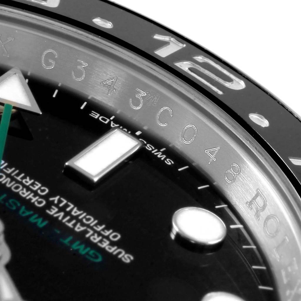 This close-up angle of the Rolex GMT-Master 116710 Men's Stainless Steel Black Dial 116710 Men's Stainless Steel Black Dial watch shows the bezel, part of the face, and some hour markers.
