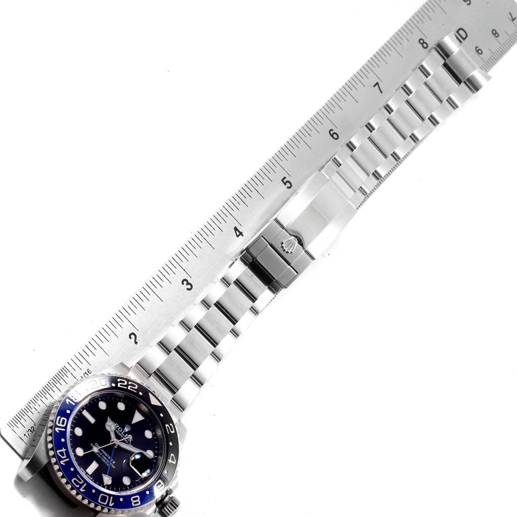 This image shows the Rolex GMT-Master 116710 Men's Stainless Steel Black Dial 116710 Men's Stainless Steel Black Dial watch face, bracelet, and clasp, alongside a ruler for measurement.