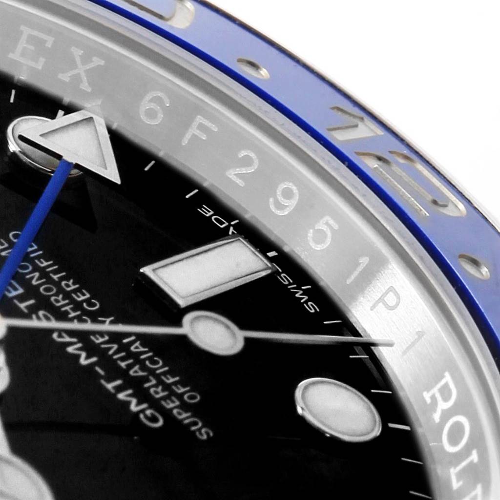 This close-up of a Rolex GMT-Master 116710 Men's Stainless Steel Black Dial 116710 Men's Stainless Steel Black Dial shows part of the watch face, the bezel, and some hour markers.