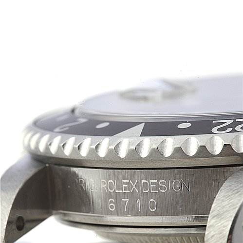 Close-up, side angle of a Rolex GMT-Master 16710 Men's Stainless Steel Black Dial 16710 Men's Stainless Steel Black Dial watch, showing the bezel, case, and engraved model number "16710".