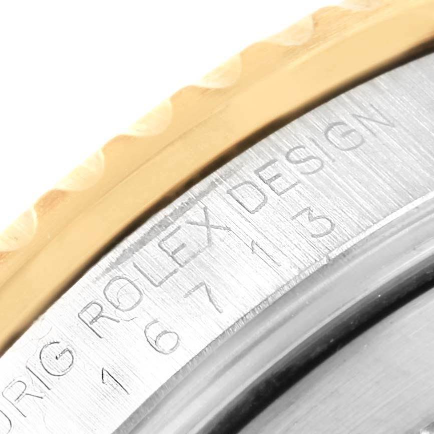 This image shows a close-up of the engraved case back and edge of the bezel of a Rolex GMT-Master 16713 Men's Stainless Steel Black Dial 16713 Men's Stainless Steel Black Dial watch.