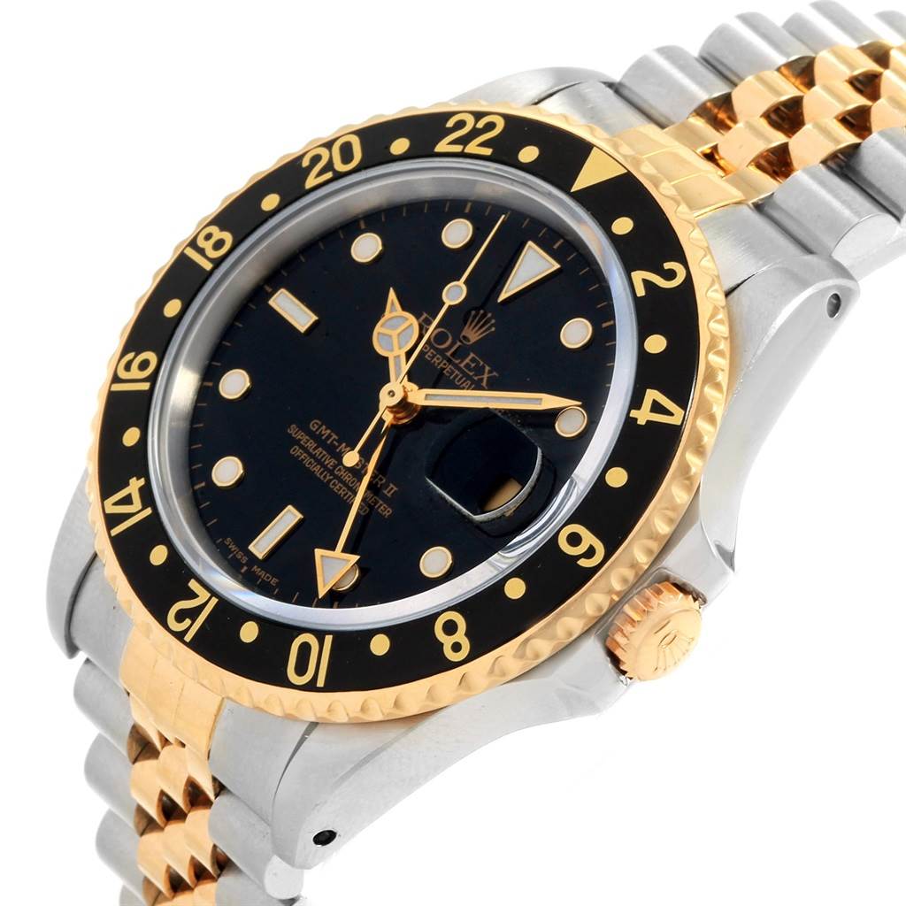 This image shows the face, bezel, and part of the bracelet of a Rolex GMT-Master 16713 Men's Stainless Steel Black Dial 16713 Men's Stainless Steel Black Dial watch from an angled perspective.