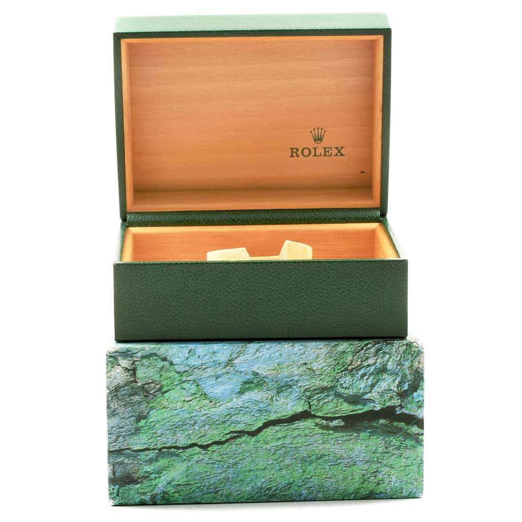 This image shows an open green Rolex GMT-Master 16713 Men's Stainless Steel Black Dial 16713 Men's Stainless Steel Black Dial watch box, with a wooden interior and the Rolex logo.