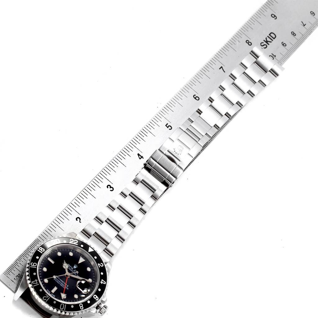 The image shows part of the dial and the full bracelet of a Rolex GMT-Master 16710 Men
s Stainless Steel Black Dial 16710 Men
s Stainless Steel Black Dial watch, aligned with a ruler for measurement.