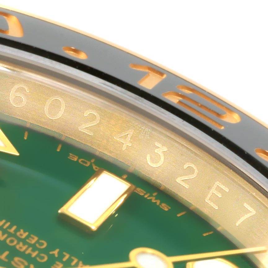 The image shows a close-up of the bezel, dial, and markers of a Rolex GMT-Master 116718LN Men's Yellow Gold Green Dial 116718LN Men's Yellow Gold Green Dial watch.