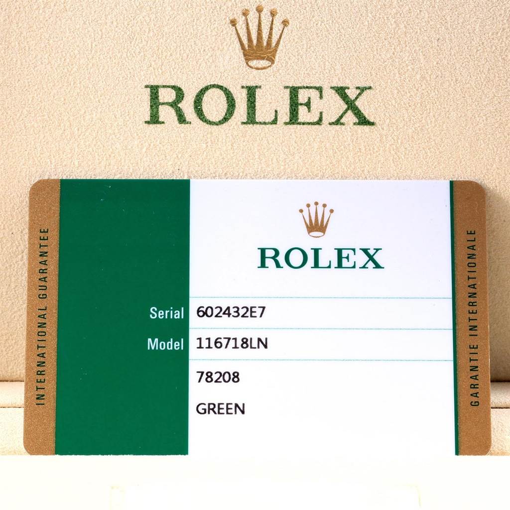 The image shows a warranty card for a Rolex GMT-Master 116718LN Men's Yellow Gold Green Dial 116718LN Men's Yellow Gold Green Dial model 116718LN, displaying the serial number, model number, and details.