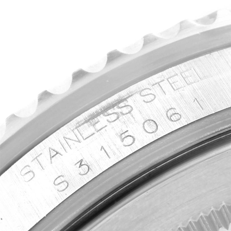 This image shows a close-up of the side engraving and bezel teeth of a Rolex GMT-Master, indicating stainless steel.