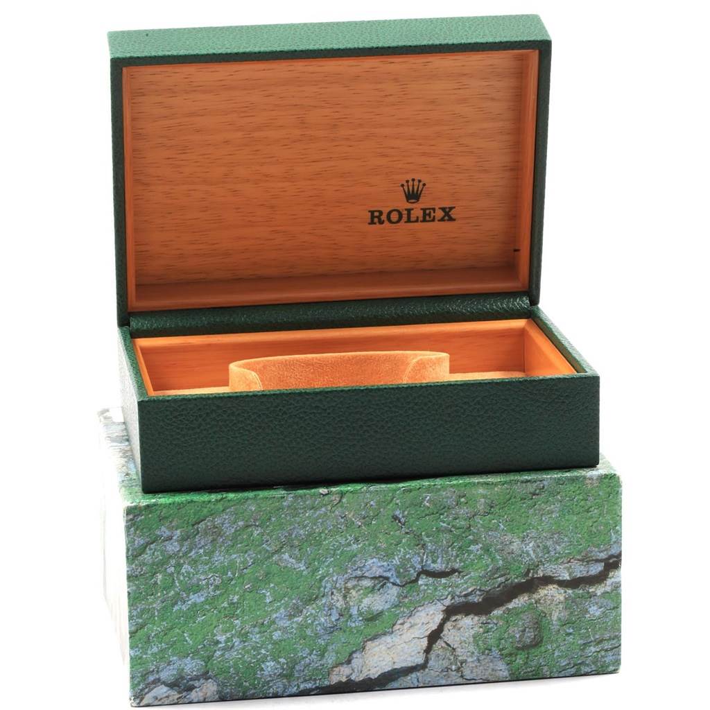 This image shows an open green Rolex GMT-Master 16700 Men's Stainless Steel Black Dial 16700 Men's Stainless Steel Black Dial watch box with its inner wooden lining and cushion inside.