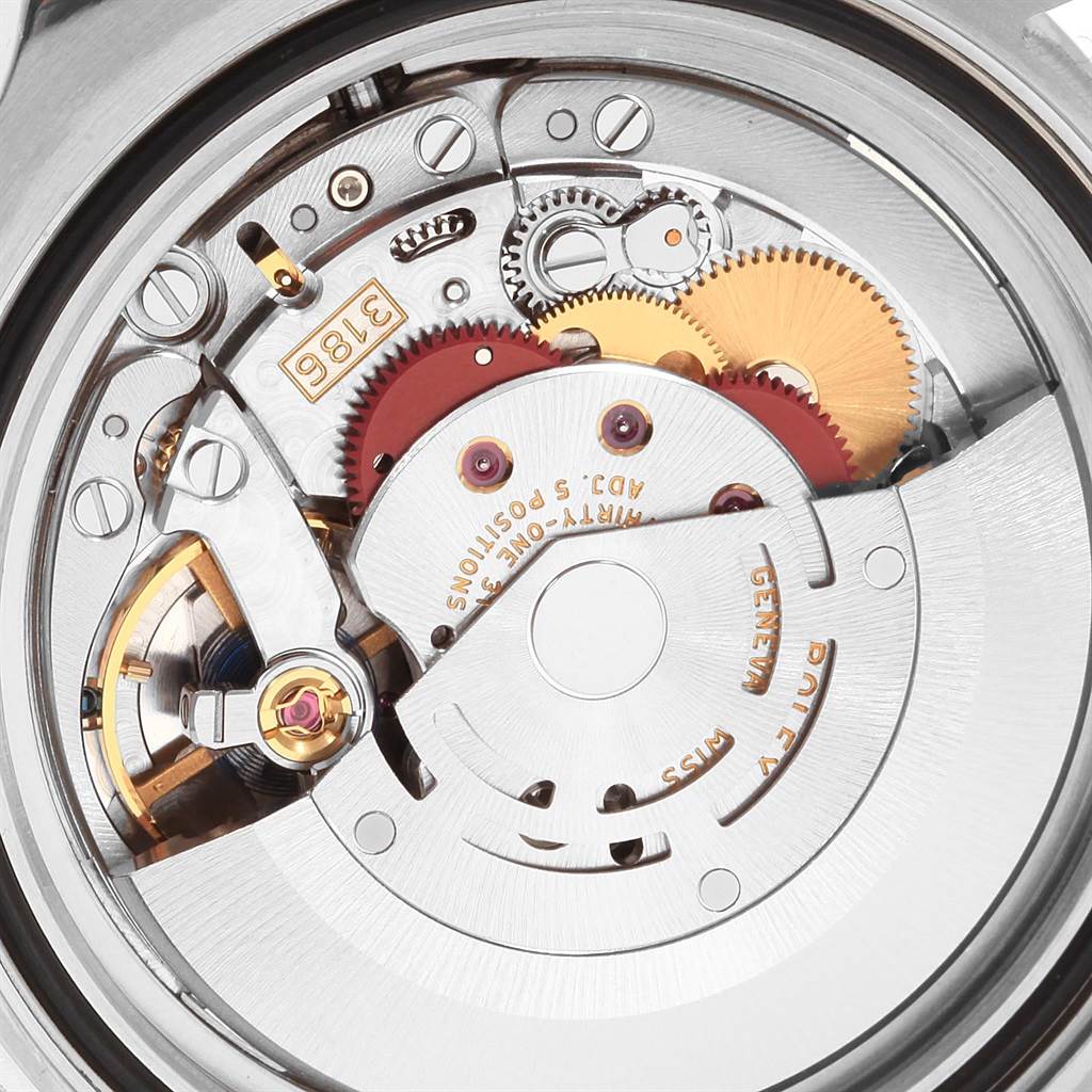 The image shows a close-up view of the movement of the Rolex GMT-Master 116710 Men's Stainless Steel Black Dial 116710 Men's Stainless Steel Black Dial watch, highlighting its intricate gears and components.