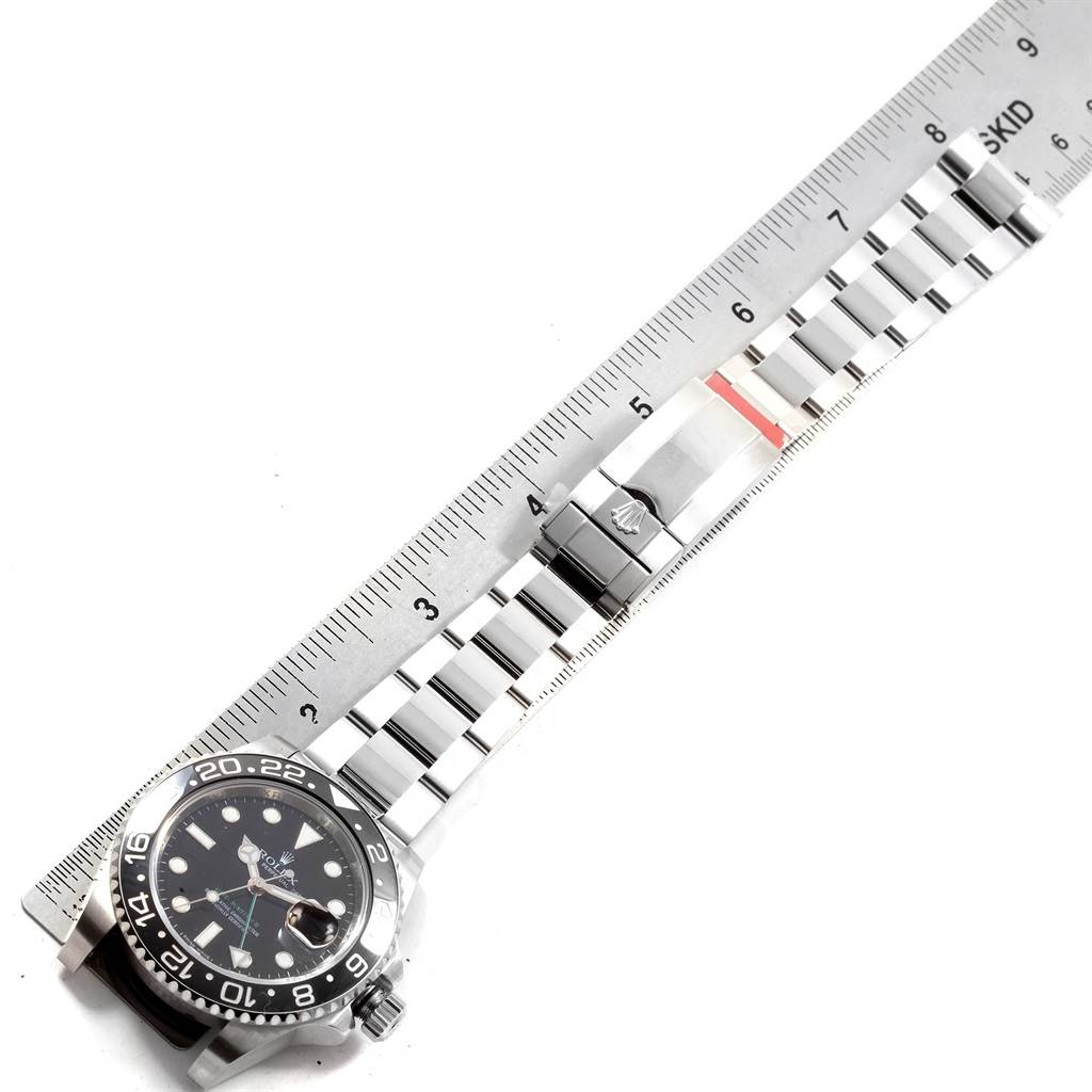 The image shows a Rolex GMT-Master 116710 Men's Stainless Steel Black Dial 116710 Men's Stainless Steel Black Dial watch laid flat with an attached measurement ruler.