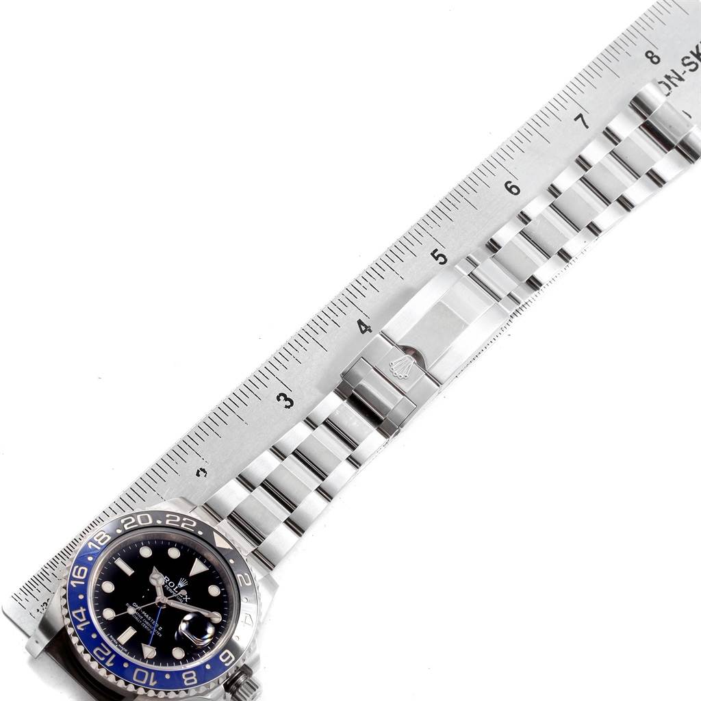 The image shows the Rolex GMT-Master 116710 Men's Stainless Steel Black Dial 116710 Men's Stainless Steel Black Dial watch face and bracelet, with a ruler measuring the bracelet's length.