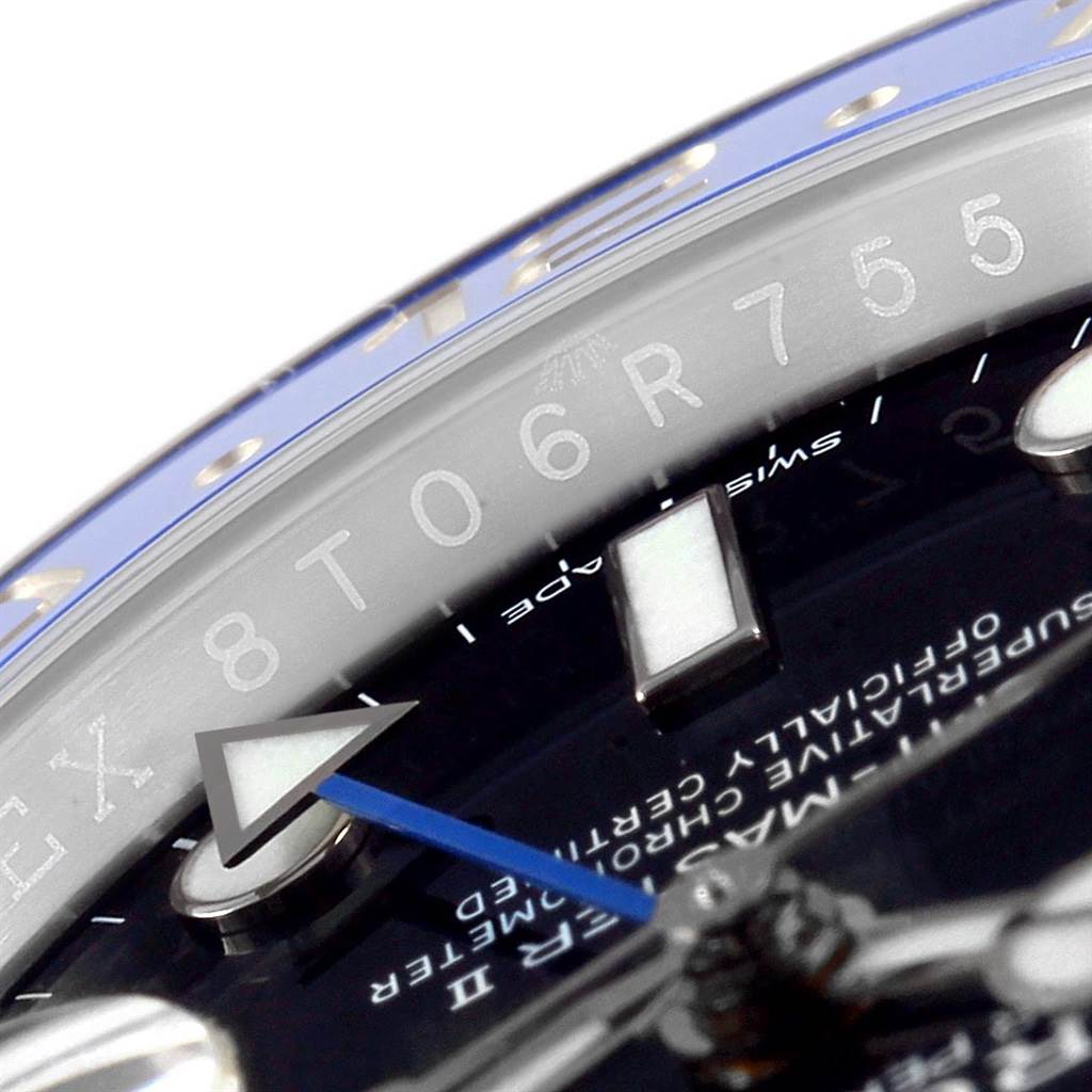 This close-up shows the dial and chapter ring of a Rolex GMT-Master 116710 Men's Stainless Steel Black Dial 116710 Men's Stainless Steel Black Dial, highlighting the blue GMT hand and part of the serial number.