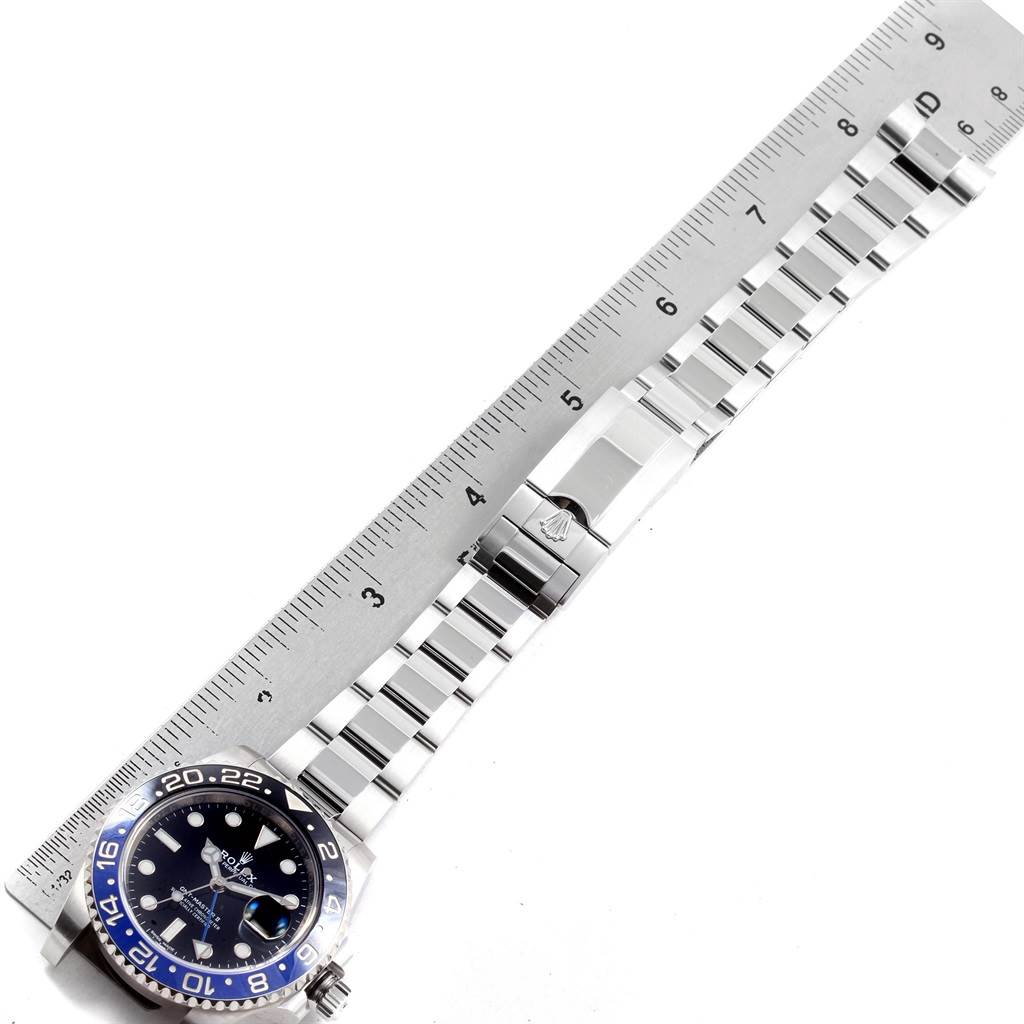 The image shows an overhead view of the Rolex GMT-Master 116710 Men's Stainless Steel Black Dial 116710 Men's Stainless Steel Black Dial watch, displaying the dial, bezel, and full bracelet alongside a measuring ruler.