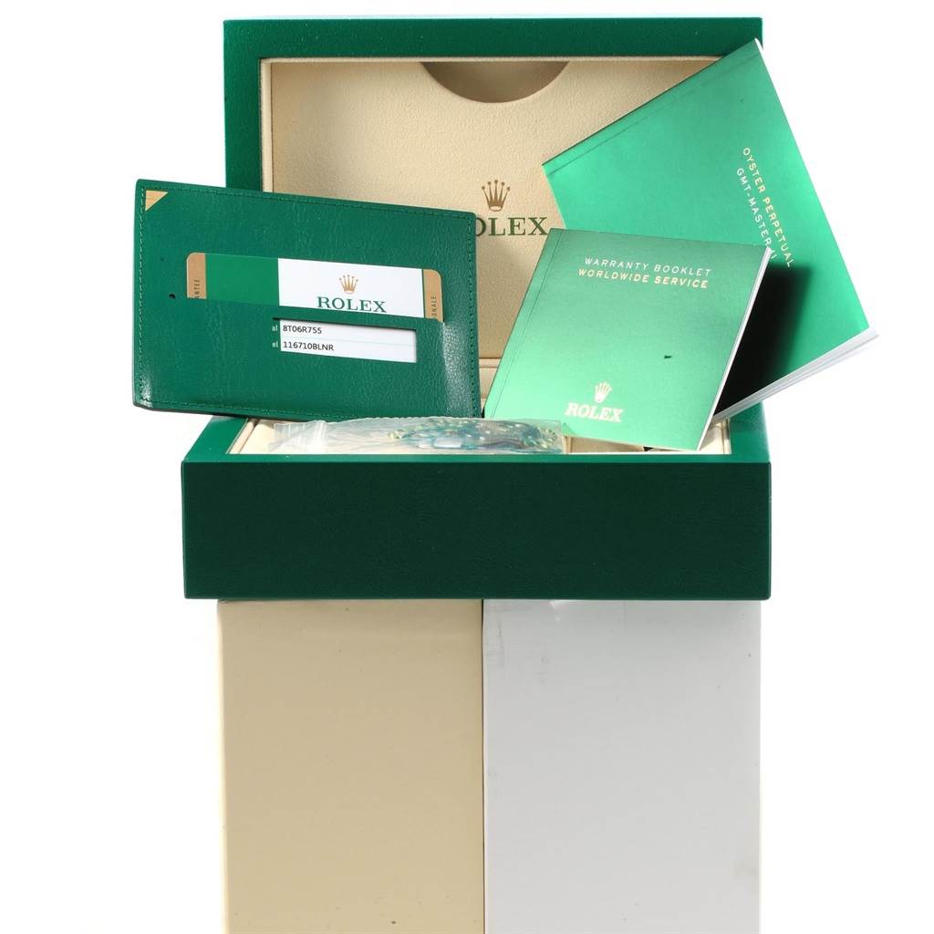 This image shows the packaging, warranty card, and booklets for a Rolex GMT-Master 116710 Men's Stainless Steel Black Dial 116710 Men's Stainless Steel Black Dial watch.