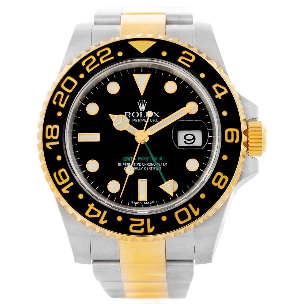 This image shows a frontal view of a Rolex GMT-Master 116713 Men
s Stainless Steel Black Dial 116713 Men
s Stainless Steel Black Dial II watch, highlighting its black dial, gold bezel, and two-tone bracelet.