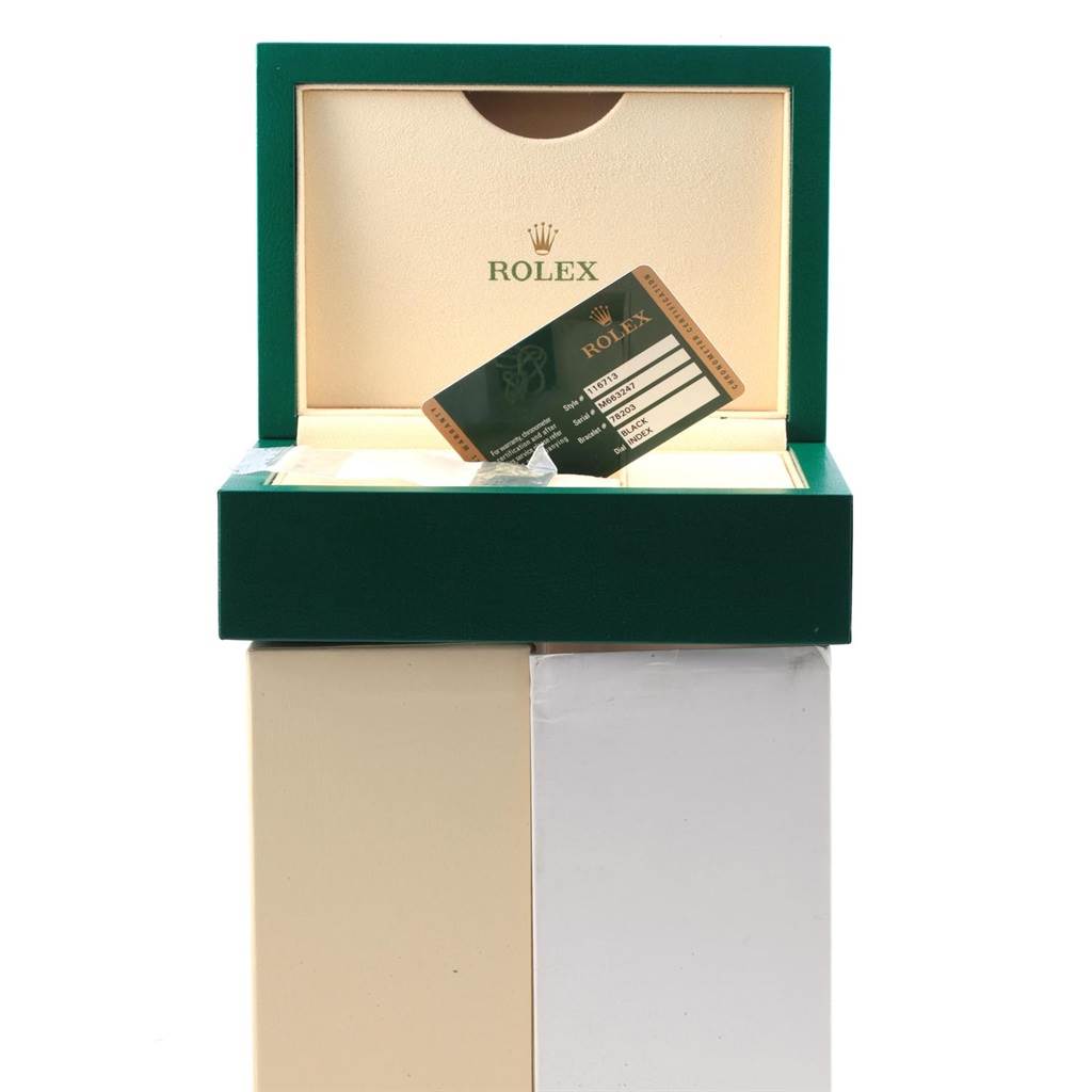 The image shows the open box of a Rolex GMT-Master 116713 Men
s Stainless Steel Black Dial 116713 Men
s Stainless Steel Black Dial watch with a certification card inside.