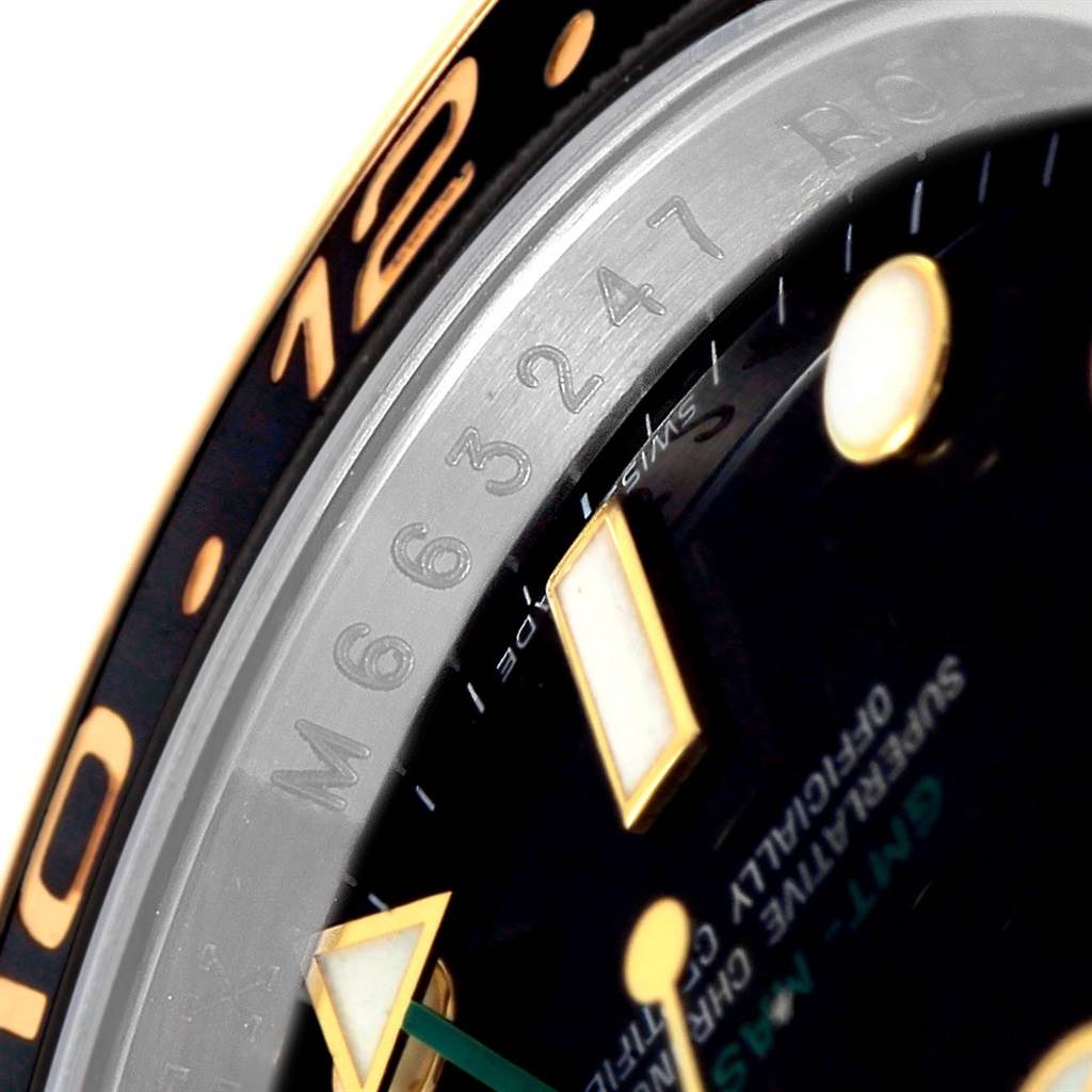 The image shows a close-up angled view of the dial, bezel, and part of the rehaut of a Rolex GMT-Master 116713 Men
s Stainless Steel Black Dial 116713 Men
s Stainless Steel Black Dial watch.
