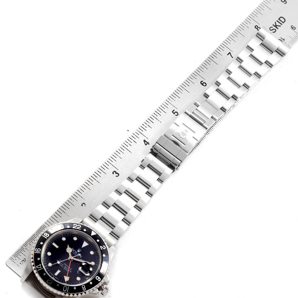 The image shows the face and partial band of a Rolex GMT-Master 20121 Men's Stainless Steel Black Dial 20121 Men's Stainless Steel Black Dial watch, measured against a ruler.