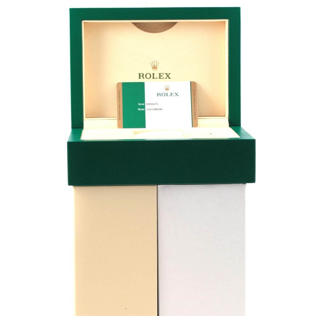 This image shows an open Rolex GMT-Master 116710 Men's Stainless Steel Black Dial 116710 Men's Stainless Steel Black Dial watch box with the warranty card displayed inside.