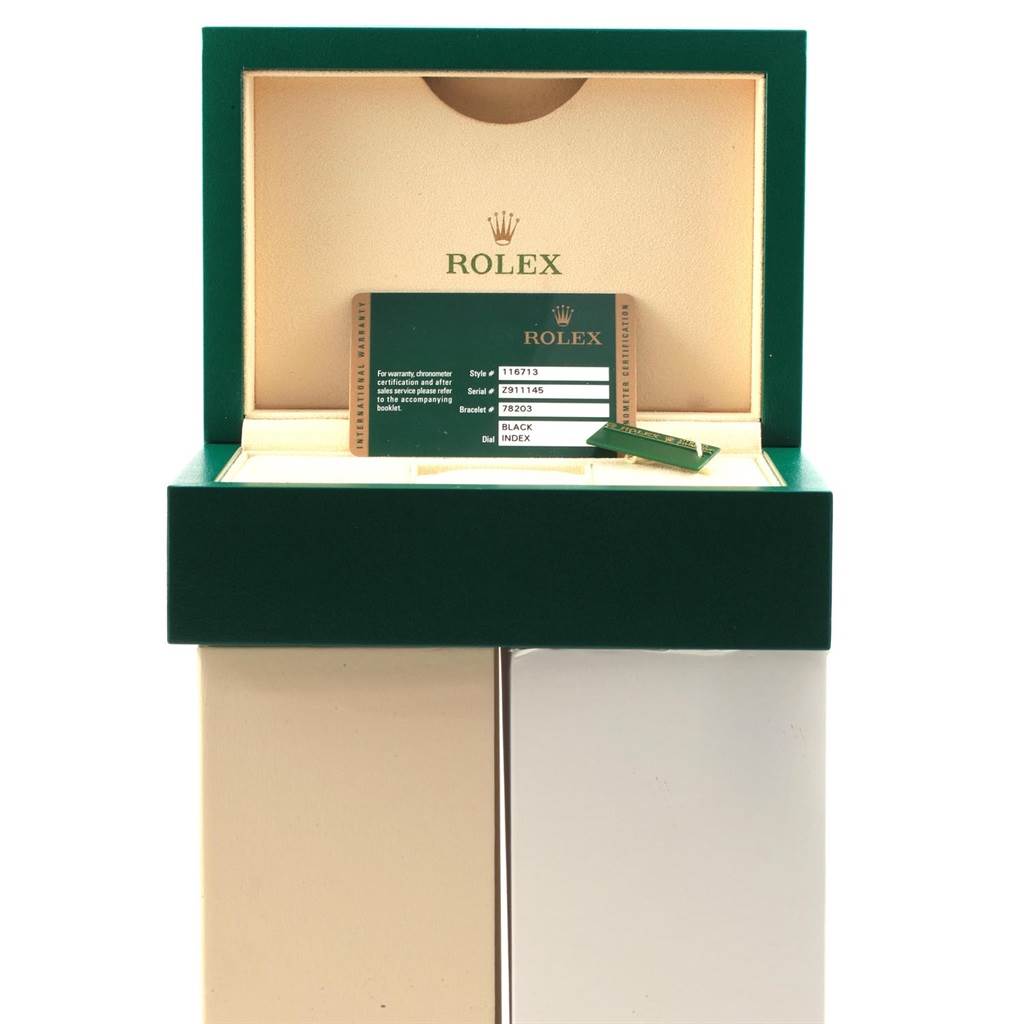 The image shows an open Rolex GMT-Master 116713 Men's Stainless Steel Black Dial 116713 Men's Stainless Steel Black Dial watch box with a warranty card and a tag inside.