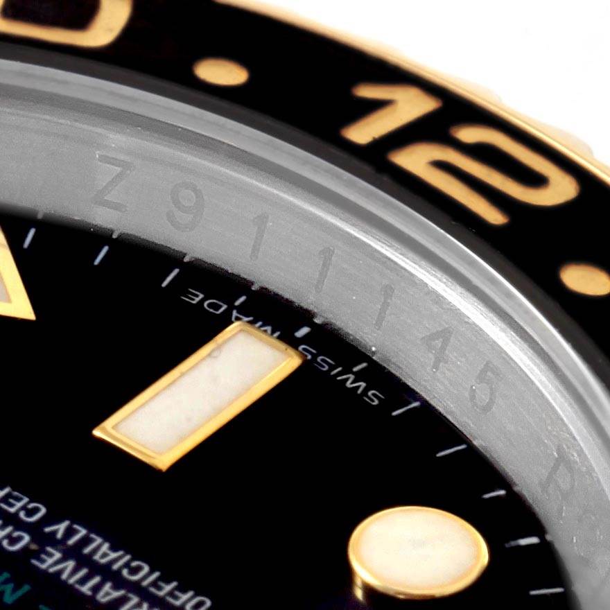 Close-up of the Rolex GMT-Master 116713 Men's Stainless Steel Black Dial 116713 Men's Stainless Steel Black Dial watch, showing part of the dial, bezel, and the Swiss-Made inscription.
