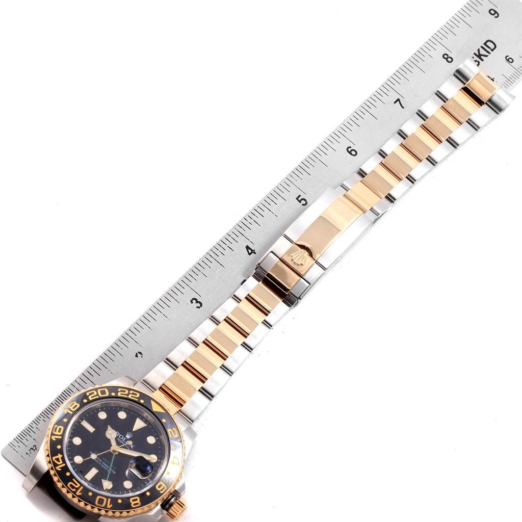 The image shows a side view of a Rolex GMT-Master 116713 Men's Stainless Steel Black Dial 116713 Men's Stainless Steel Black Dial watch, displaying the watch face and bracelet next to a ruler.