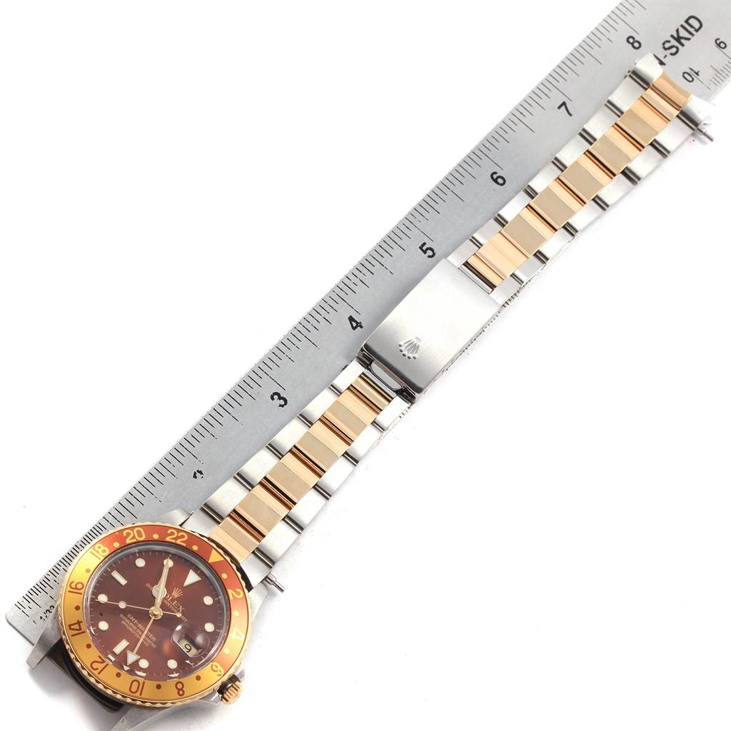 This image shows the entire Rolex GMT-Master 16753 Men's Stainless Steel Brown Dial 16753 Men's Stainless Steel Brown Dial watch laid flat next to a ruler, focusing on the bracelet and part of the bezel.