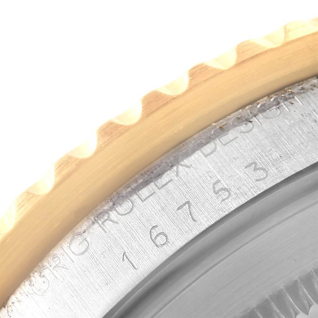 Close-up of the bezel edge and case side of the Rolex GMT-Master 16753 Men's Stainless Steel Brown Dial 16753 Men's Stainless Steel Brown Dial, showing part of the model number engraving.
